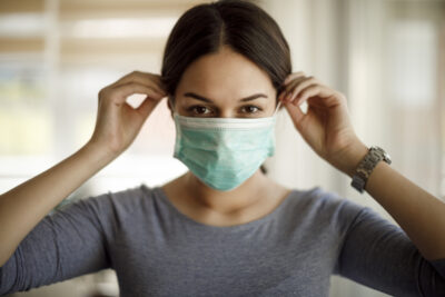 Young woman on a protective mask